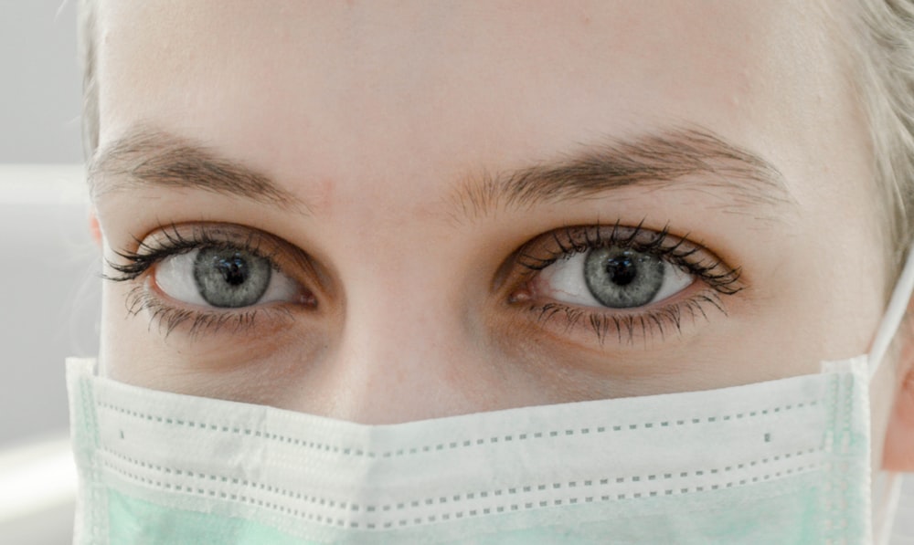 closeup photo of woman's eye wearing mask